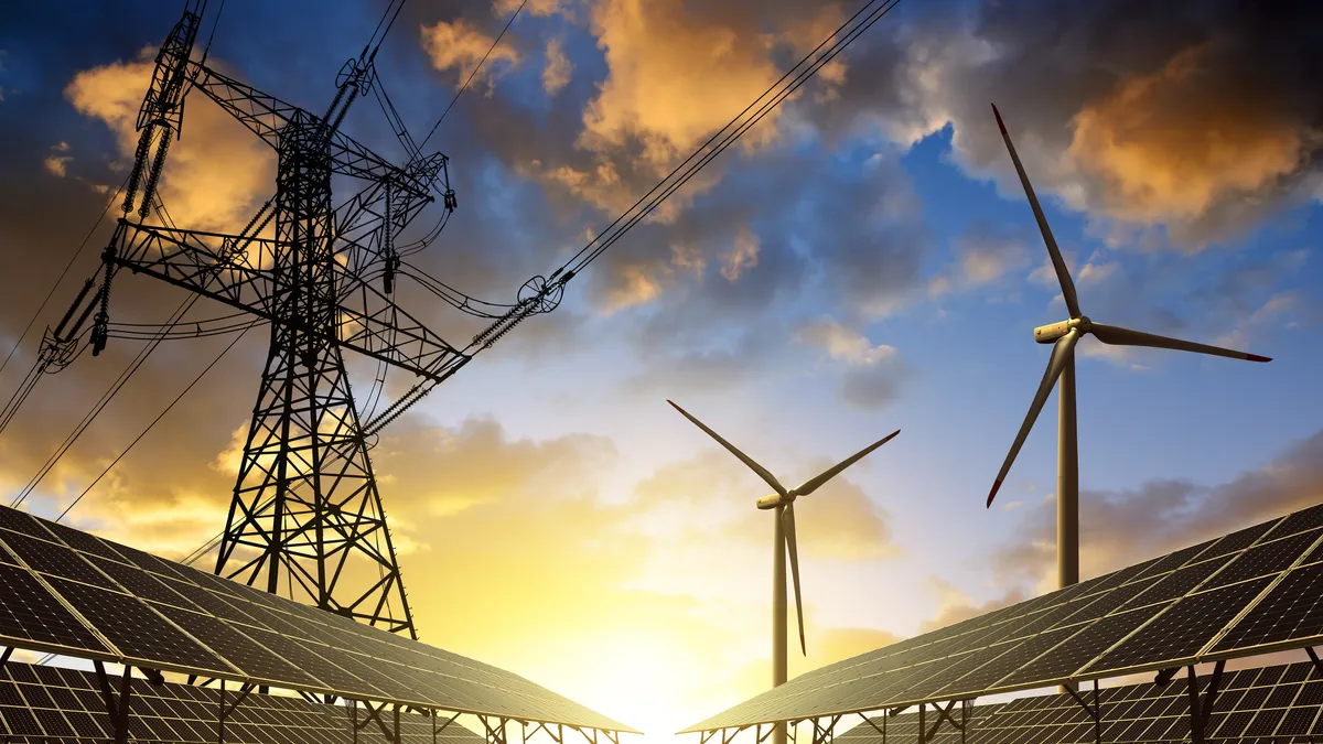 Solar panels with wind turbines and electricity pylon at sunset. Clean energy concept.