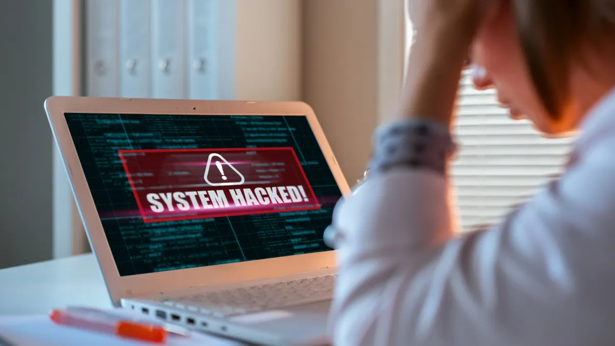 Worried woman looking at laptop.