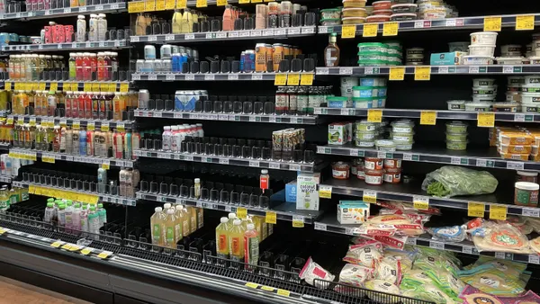 Grocery store cooler with empty space.