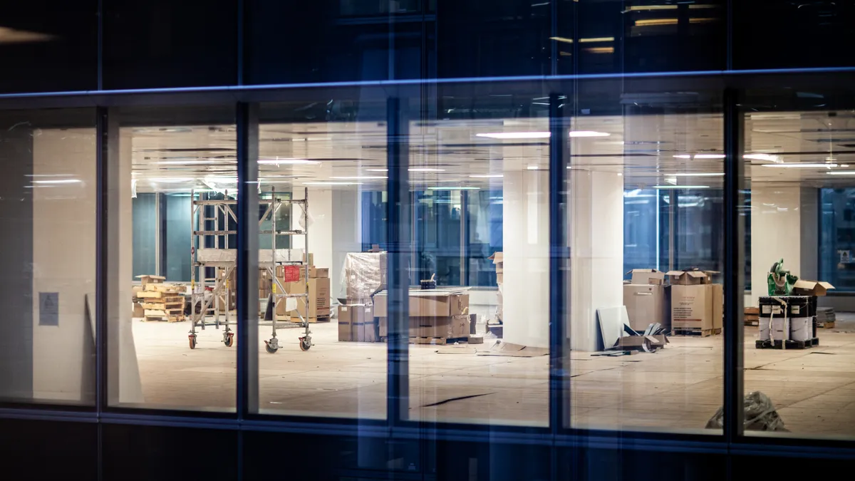 A view of windows that show renovation work in an office of a commercial building