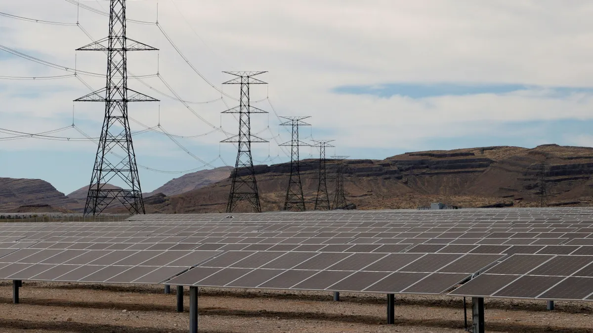 Transmission towers are shown near solar panels