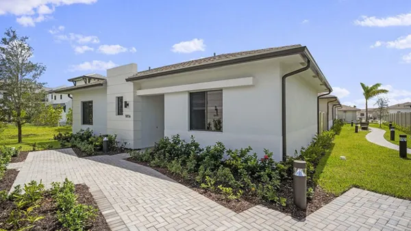 A single-family home on a green lawn.