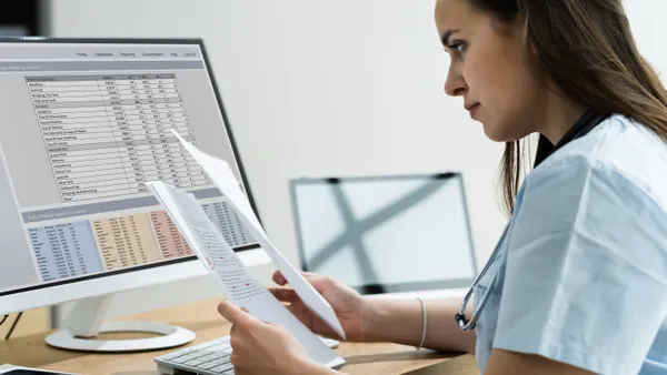 Doctor studies financial records.