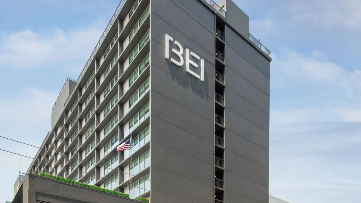 The gray exterior of the hotel tower reads "BEI" in white letters.