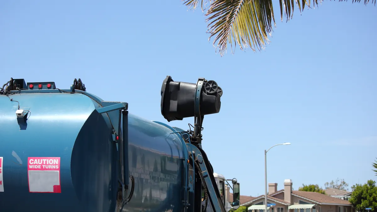 Truck collecting a cart via automated sideloader