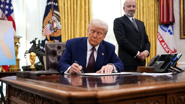 President Donald Trump, joined by Secretary of Commerce Howard Lutnick, signs an executive order on reciprocal tariffs in the Oval Office at the White House on Feb. 13, 2025 in Washington, DC