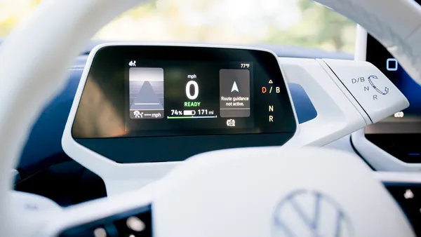 The instrument cluster in a 2023 Volkswagen ID.4 electric SUV showing the top half of a white steering wheel.