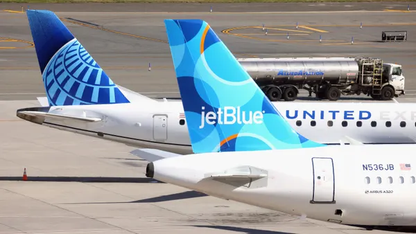 Two planes on the taxiway.