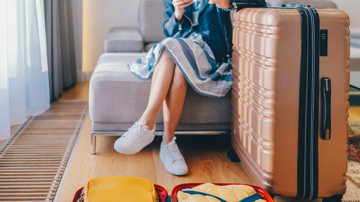 Woman paying on smartphone in hotel room