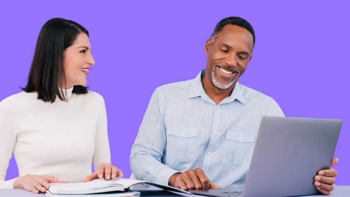 Man and women smiling while working together,