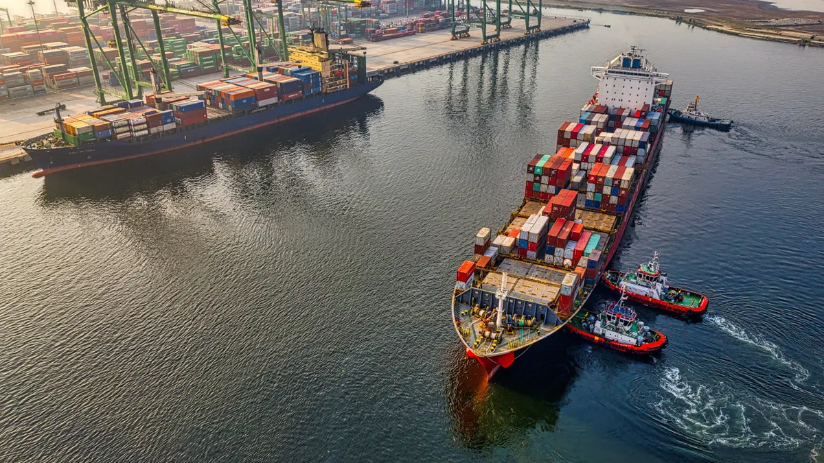 Red and blue cargo ship on water body