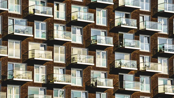 A series of windows and balconies on an apartment building.