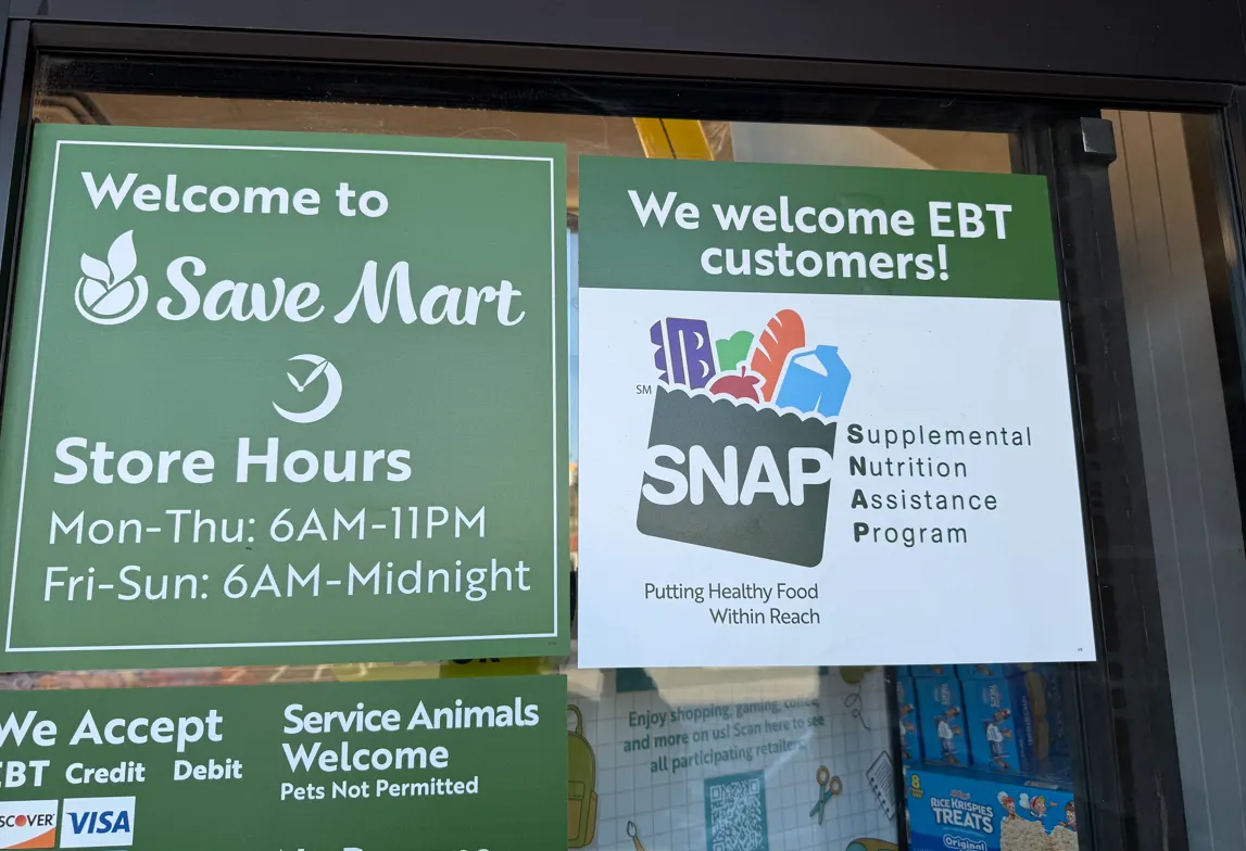 A sign about acceptance of SNAP EBT at a grocery store.