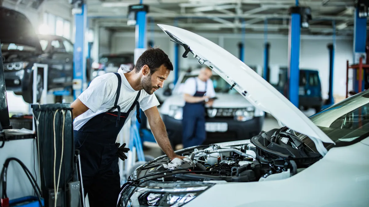 Mechanic looking at car engine