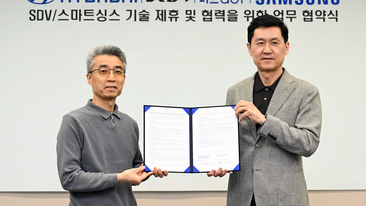 Chang Song (left), President and Head of Hyundai Motor Group Advanced Vehicle Platform Division; and Kyungwhoon Cheun, President, CTO of DX Division at Samsung Electronics and Head of Samsung Research together hold the signed agreement at a signing ceremony announcing the new collaboration.