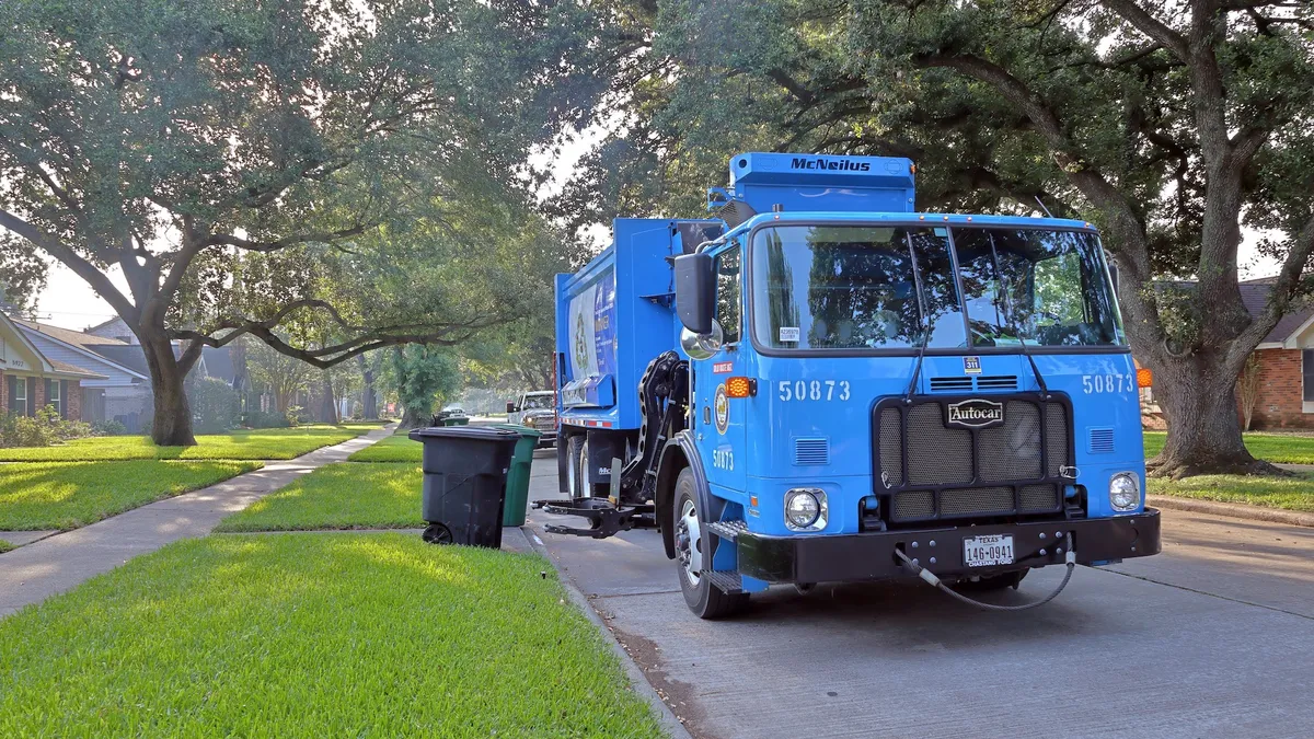 Waste truck on the street collecting