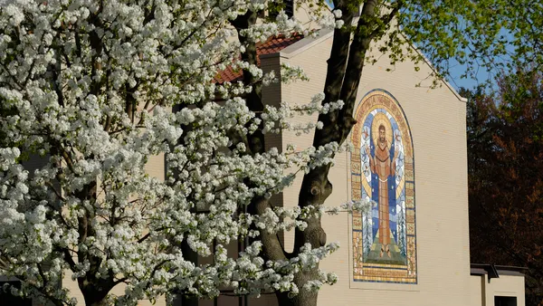 White brick building with stained glass.