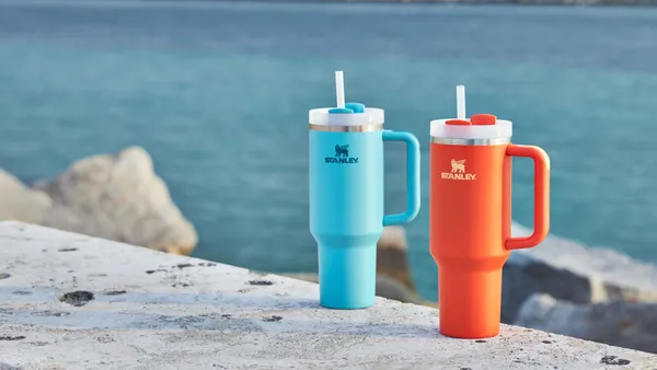 Two of Stanley's Quencher tumblers in blue and orange.