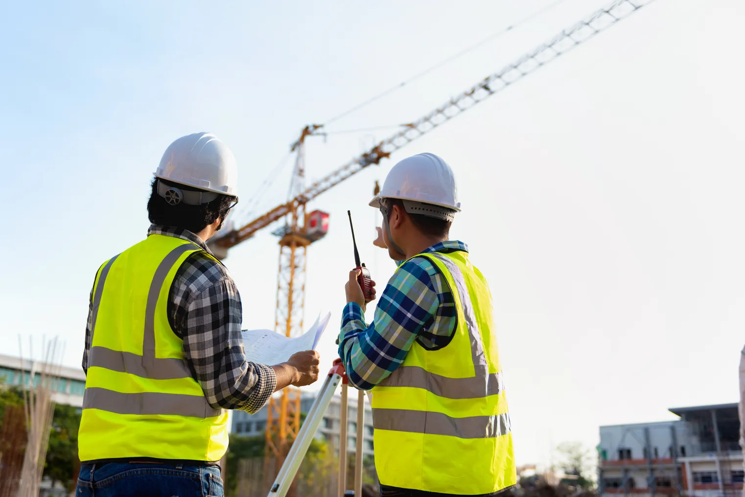 Construction engineers discussion with architects at construction site