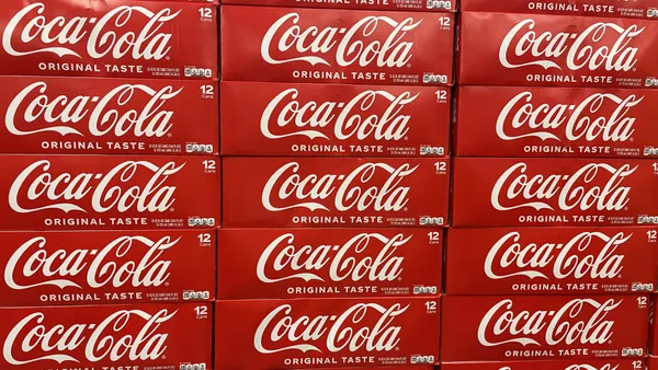 Boxes of Coca-Cola in a grocery store.