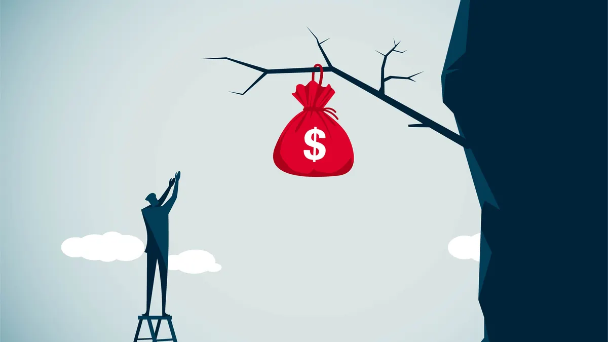 A man on a ladder tries to reach a red bag of money that is clinging to a branch on a cliff above him