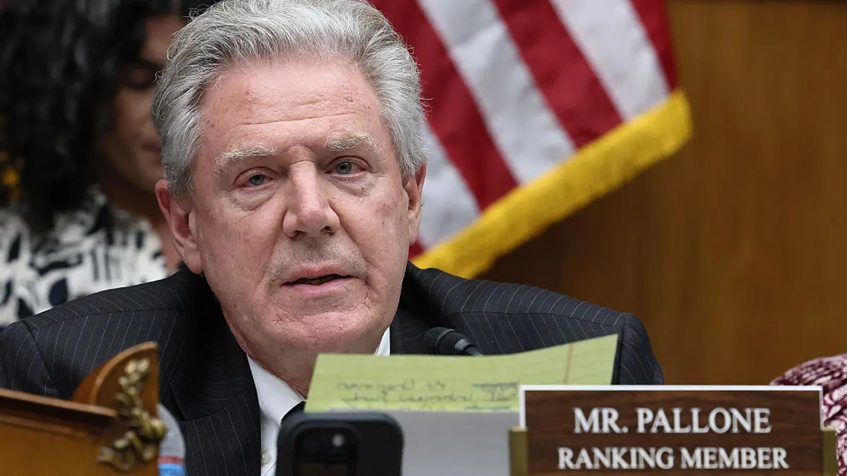 A close-up of Ranking Member Frank Pallone in front of a blurred American flag.