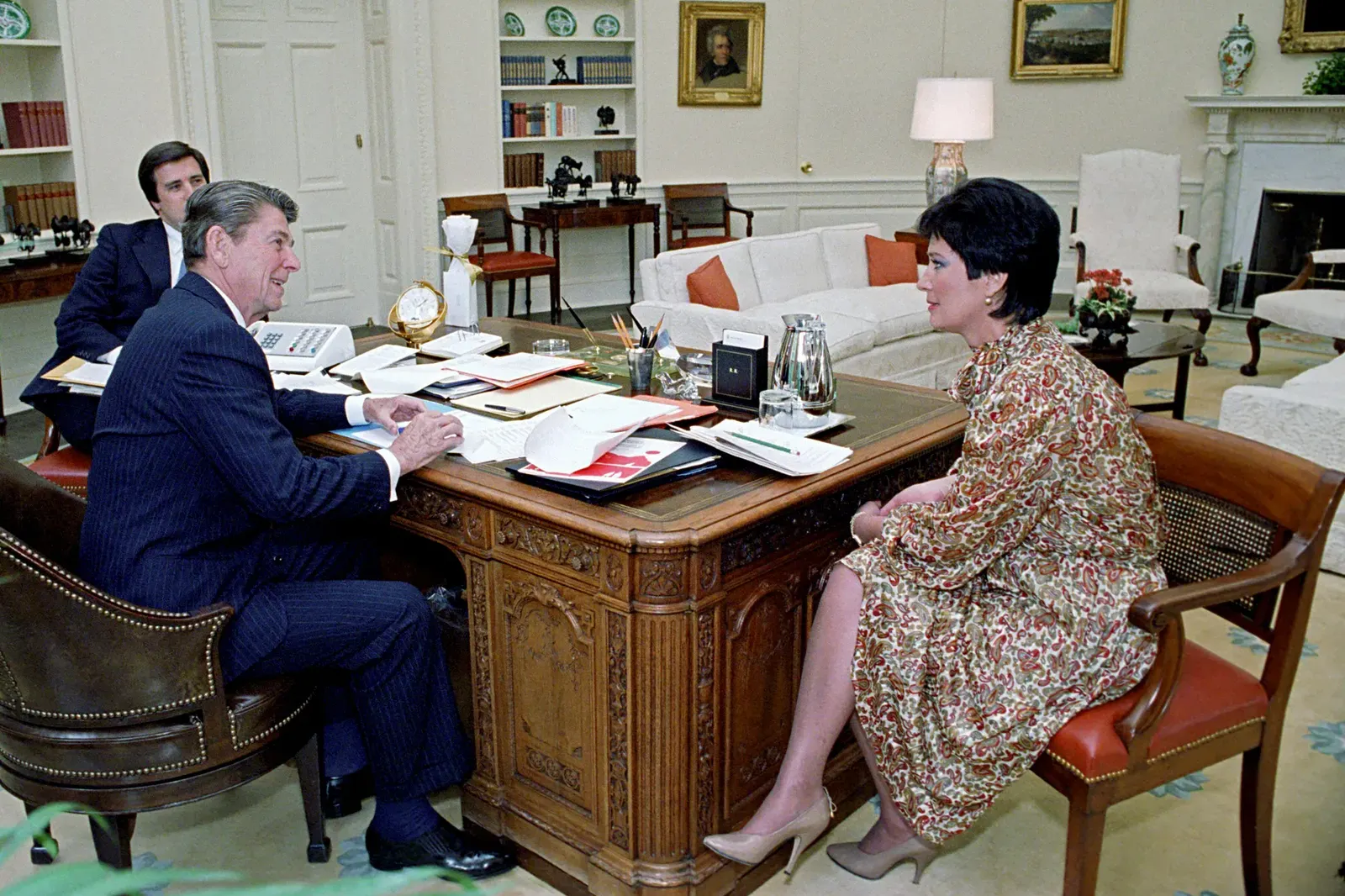 President Ronald Reagan and EPA Administrator sit in the Oval Office, with another staff member to the left