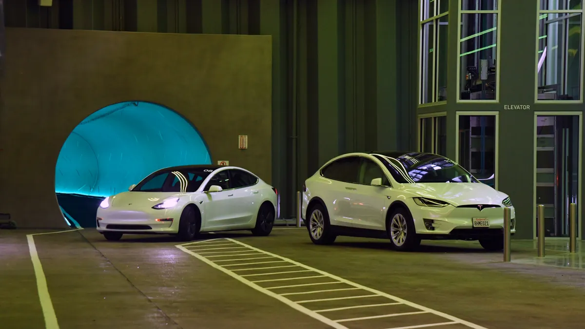 Tesla cars drive in the Central Station during a media preview of the Las Vegas Convention Center Loop on April 9, 2021 in Las Vegas, Nevada.