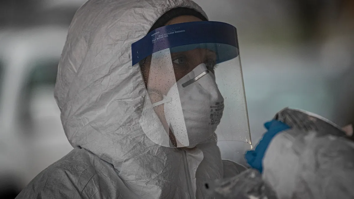 New Jersey Air National Guard medics with the 108th Wing process specimens at a COVID-19 Community-Based Testing Site at the PNC Bank Arts Center in Holmdel, N.J., March 23, 2020. The testing site, es