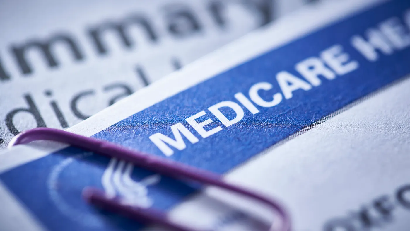 A piece of paper with the word "Medicare" emblazoned on a blue background