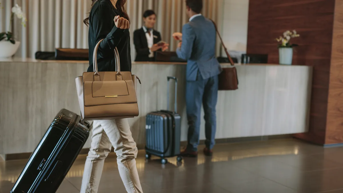 Guest standing at hotel check-in desk