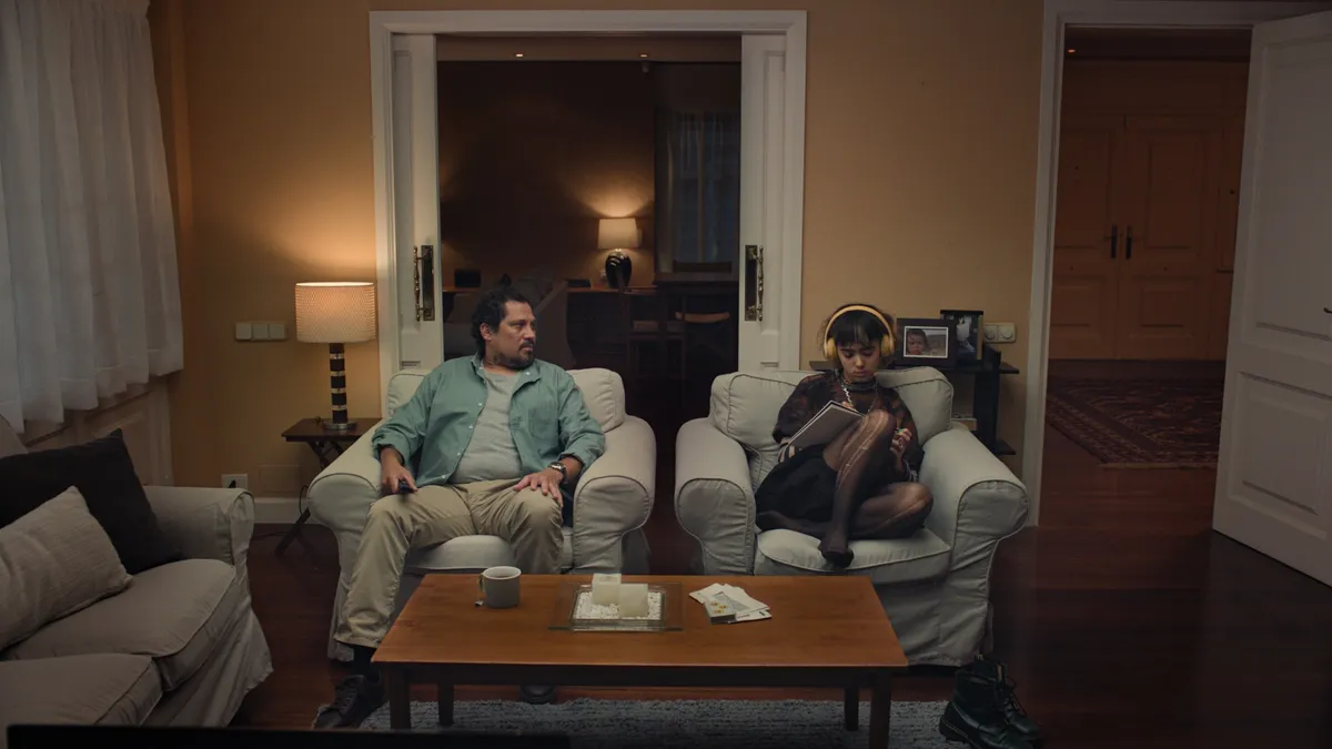 A still from one ad shows a father and daughter sitting side-by-side on armchairs.