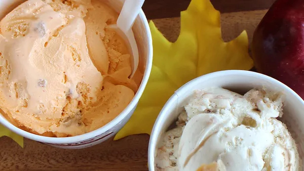 A photo of ice cream from Stewart's Shops in two cups on a table with some fall leaves.