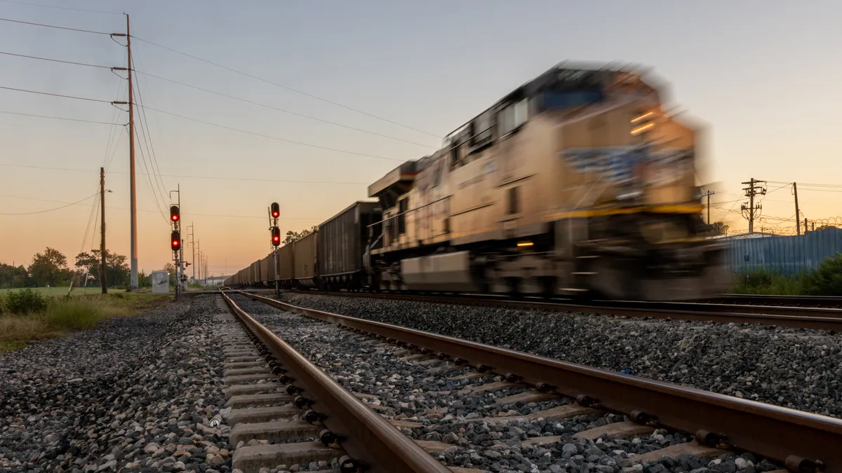 A freight train is blurred as it's seen speeding down the track