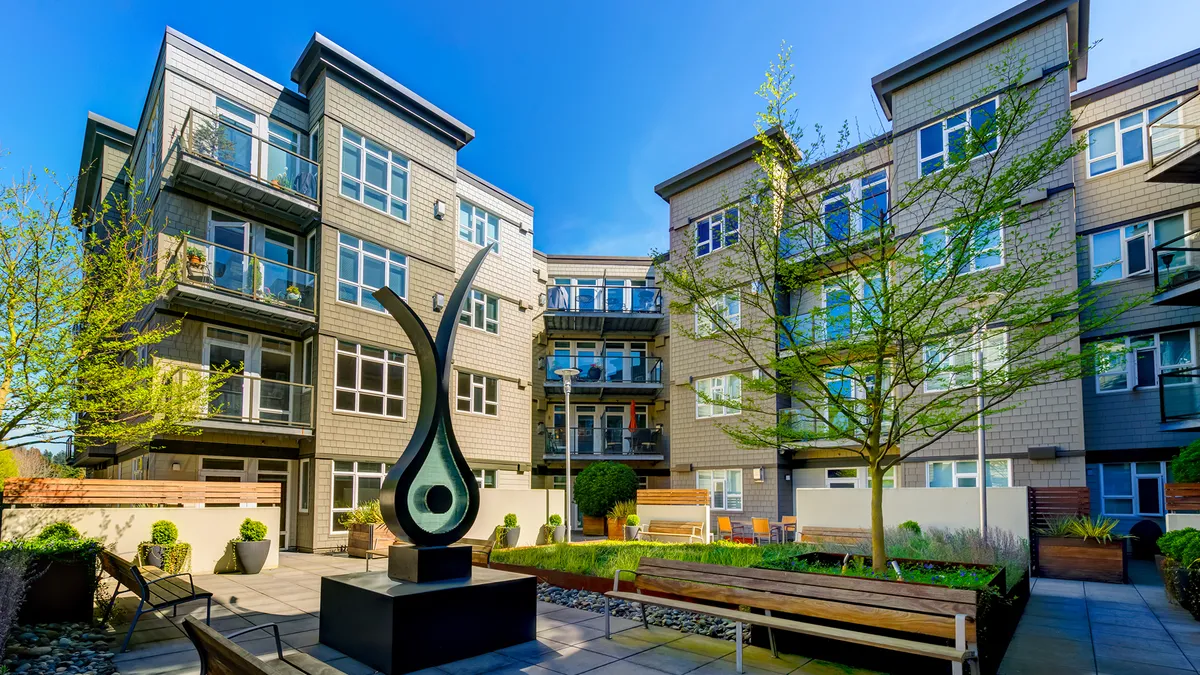 Brown four-story apartment buildings.