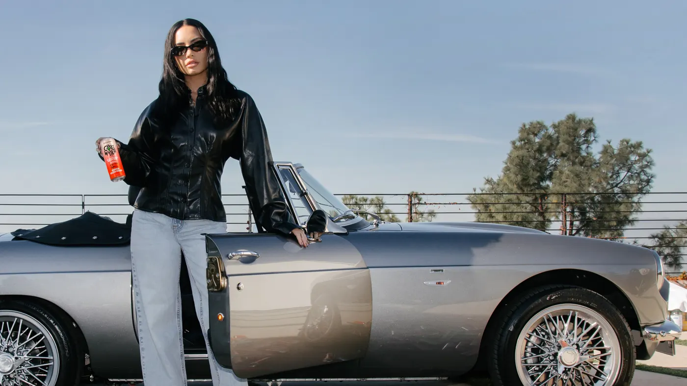 Demi Lovato poses with Caliwater