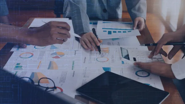 Colleagues working on charts
