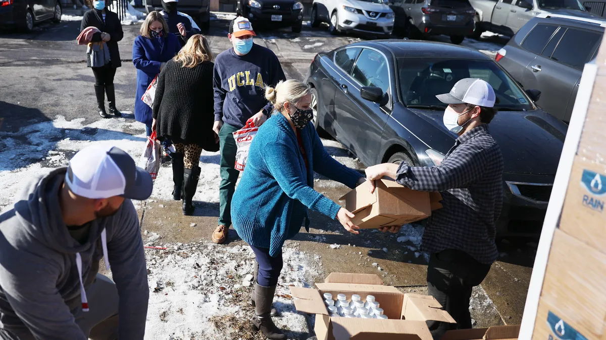 Mark Majkrzak gives out bottles of water to people in need on Feb. 19, 2021 in, Austin, Texas, in the wake of Winter Storm Uri.