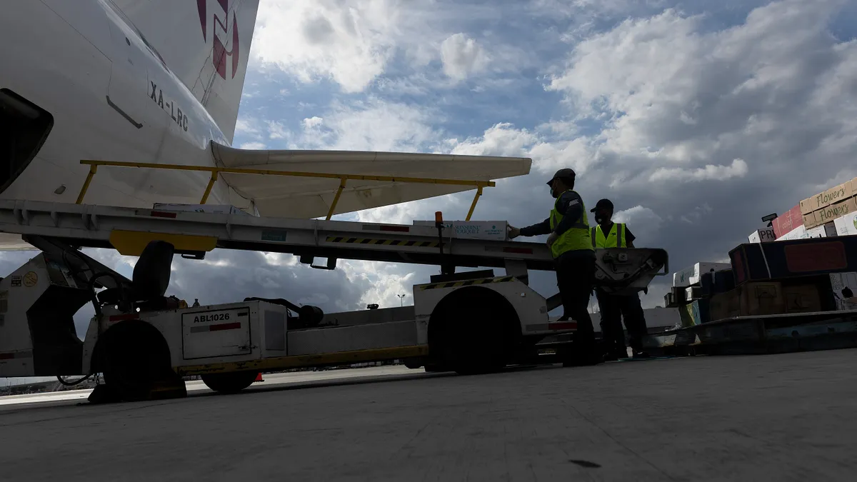 Workers unload flowers from a plane before being sent for inspection by U.S. Customs and Border Protection Agriculture Specialists for foreign pests or diseases in the Avianca Cargo Warehouse at Miami International Airport on February 08, 2022 in Miami, Florida.