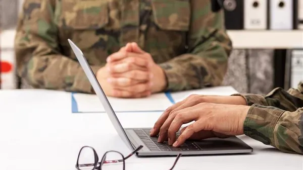 Stock photo of two military personnel at a table.