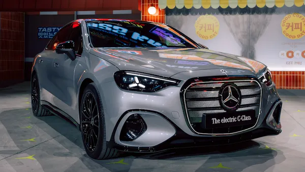 A silver electric Mercedes-Benz C-Class on display at a media event in Seoul.