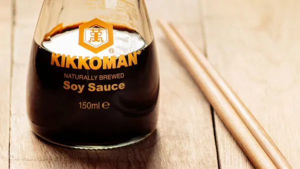 A closeup of a Kikkoman soy sauce bottle.