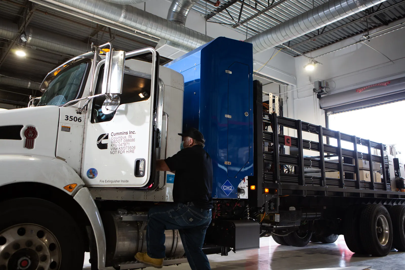 A hydrogen truck and driver prepare to leave a Cummins plant