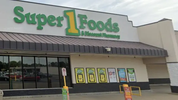 Exterior of a supermarket with a sign that reads "Super 1 Foods & Discount Pharmacy"