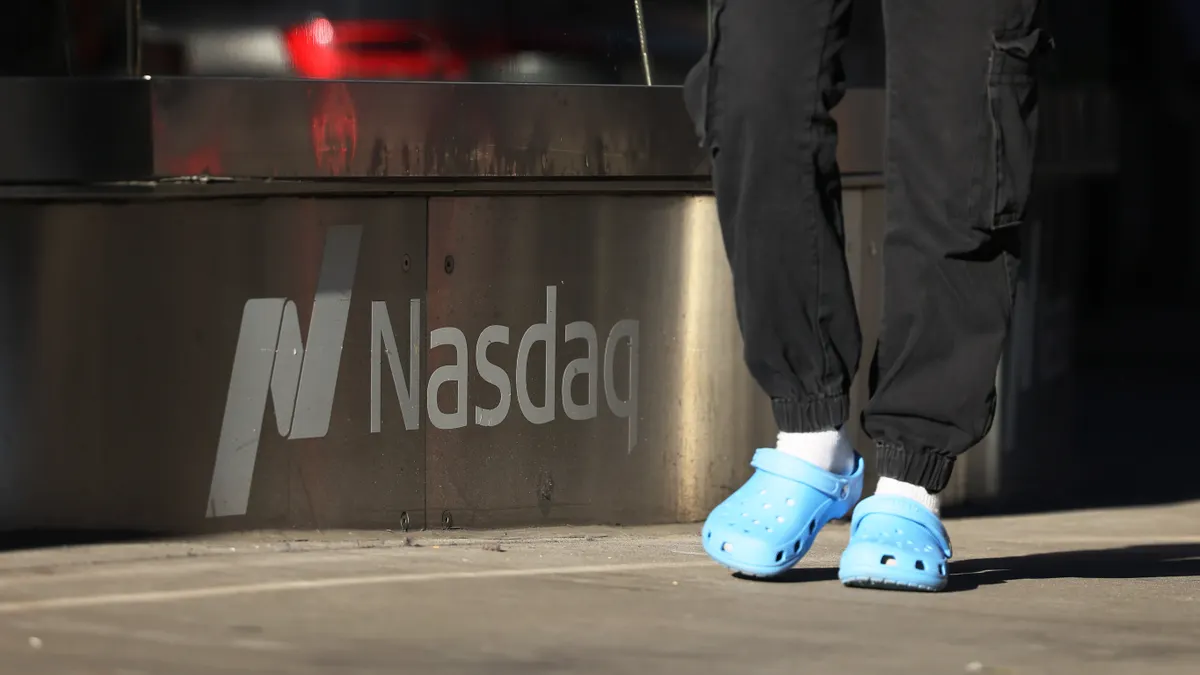 People walk past the Nasdaq MarketSite on October 12, 2022 in New York City.