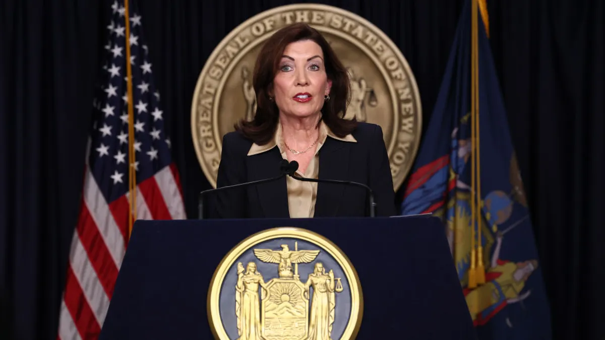 Kathy Hochul speaks at a podium.