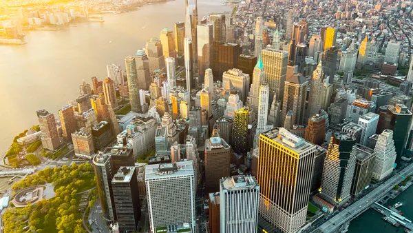 An aerial view of the Manhattan skyline at sunset.