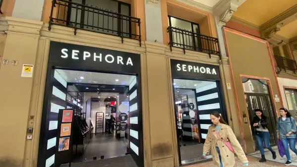 People walking past a Sephora store.