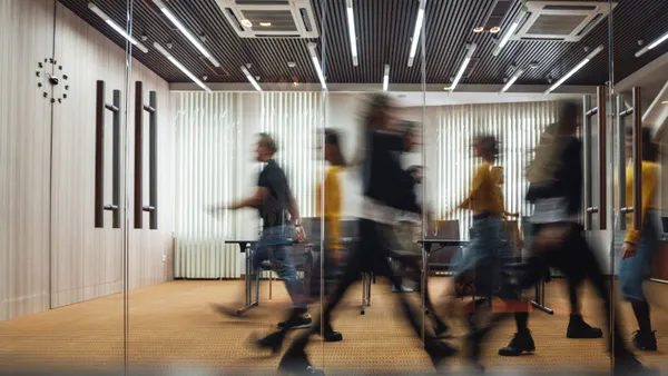 people walking in hallway