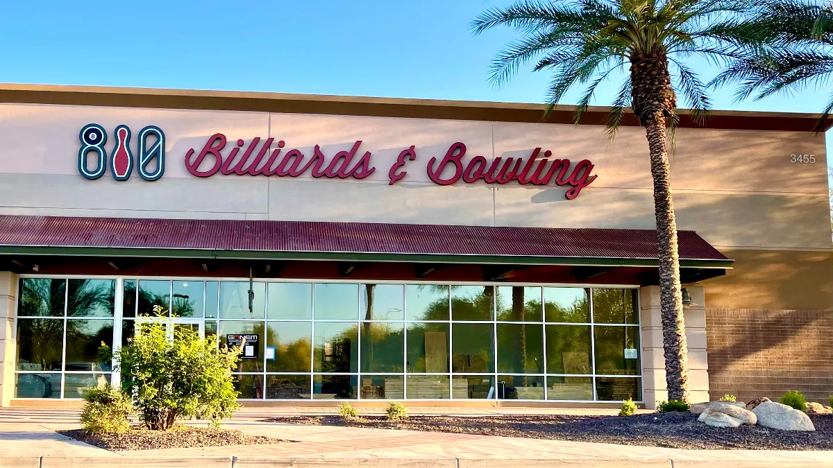 An image of a beige building with 810 Billiards & Bowling sign on the outside.